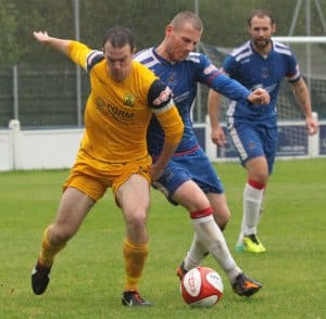 Lee Downes attempts to outmuscle a Tividale player. Pic: Dave Birt