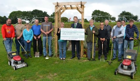 Matthew Ellis hands over the cheque to Brenda Tunstall