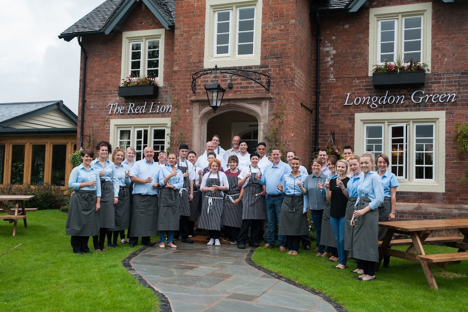 Staff celebrating the re-opening of the Red Lion, Longdon Green