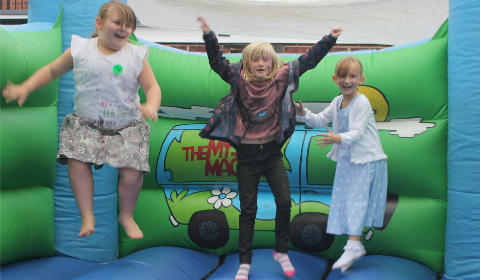 Liannerose Chatterton, Chelsea Keatley and Harriet Palfrey on the bouncy castle