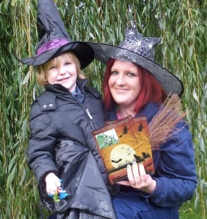 Park ranger Stacey Coleman gets ready for the Halloween trail with a young visitor