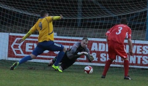 Chasetown goalkeeper John Bateman saves at the feet of an attacker. Pic: Dave Birt