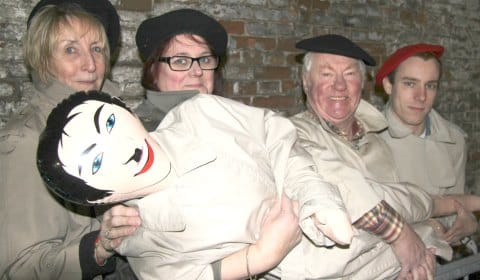 Sue Baillargeon, Karen Mather, Maurice Allden and Chris Charles with one of the props used in the play