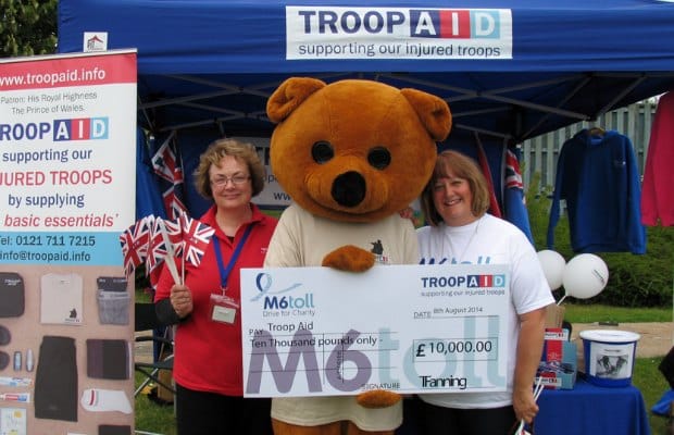 The M6 Toll cheque being handed over to Troop Aid