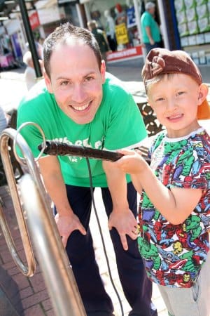 Ollie Williams tries to keep a steady hand on one of the games with Macmillan Cancer Support volunteer Amedeo Raffaelli