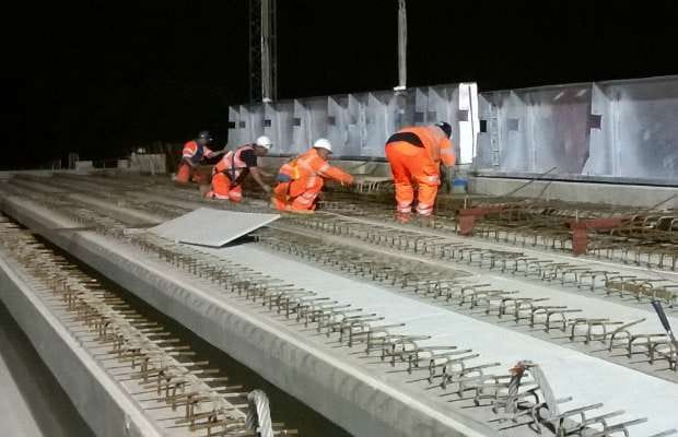 Workers putting the new Liberty Park bridge beams in