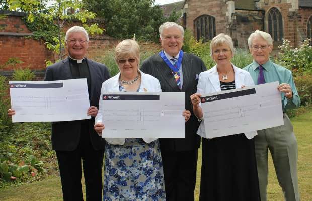 David Smith (centre) hands over the cheques to Adrian Dorber, Gay Smith, Ann Black and Peter Richardson