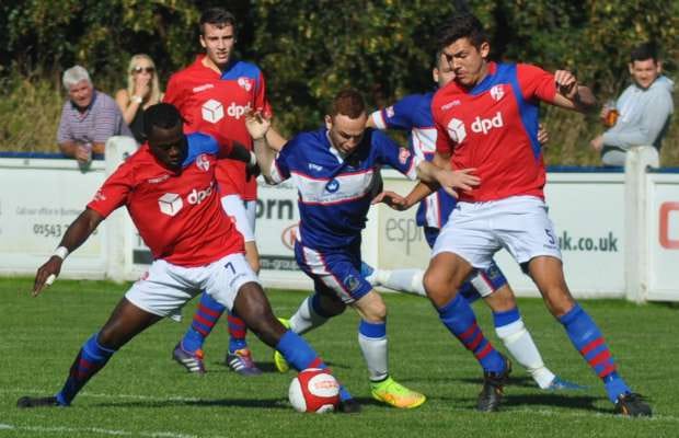 Jono Gould slips between two players. Pic: Pamela Mullins