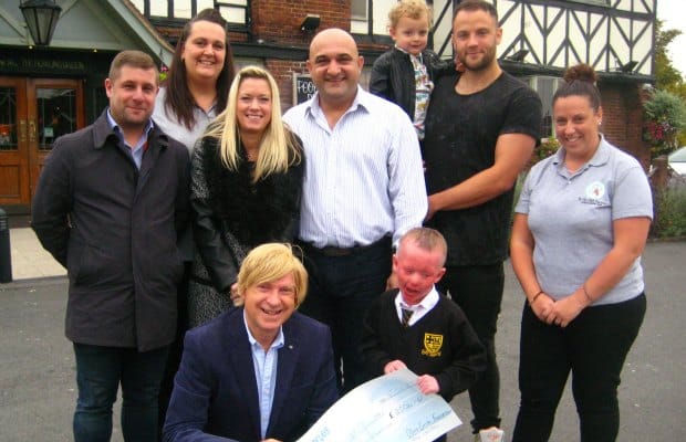 Michael Fabricant MP hands over the fundraising cheque from Lichfield Rocks
