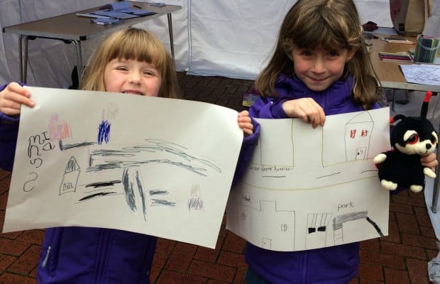 Four-year-old Ruby and seven-year-old Ellie show off their drawings