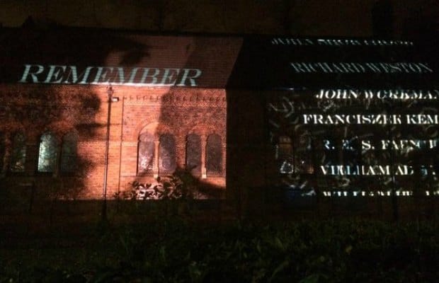 A projection of names is beamed onto the side of St Anne's Church