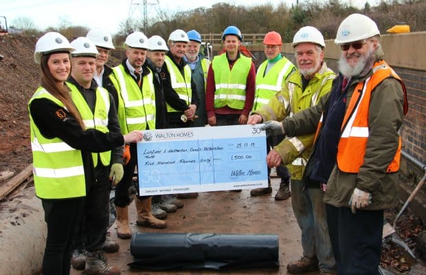 Amy Summerton presents a cheque for £500 to Lichfield and Hatherton Canals Restoration Trust directors Bob Williams and Peter Buck