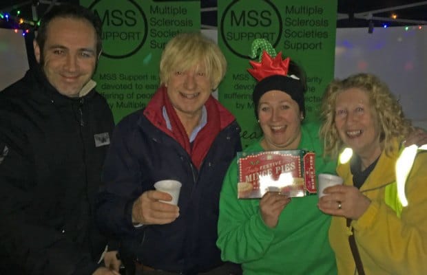 Michael Fabricat enjoying a mulled wine on the Multiple Sclerosis Support stand with local councillors
