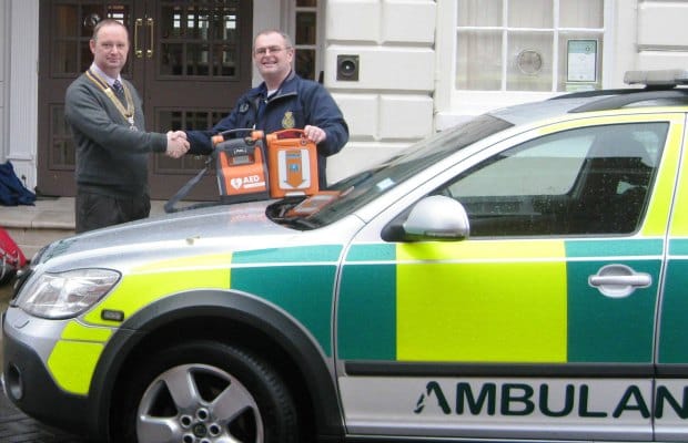 Lichfield St Chad Rotary President David Stainsby presenting the defibrillator to Mark Walker from Lichfiled Trent Valley Community First Responders