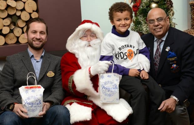 Drayton Manor director George Bryan, Devanti Palmer and Paul Jaspal from Rotary meet Father Christmas