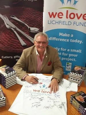 Graham Cole signing a We Love Lichfield Fund t-shirt at Arthur Price's factory shop