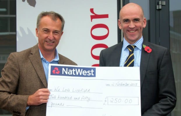Julian Fisher of We Love Lichfield being presented with a cheque for £250 by Hawksmoor managing director Richard Wain