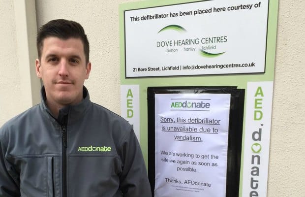 Jamie Richards from AEDdonate next to the damaged defibrillator cabinet