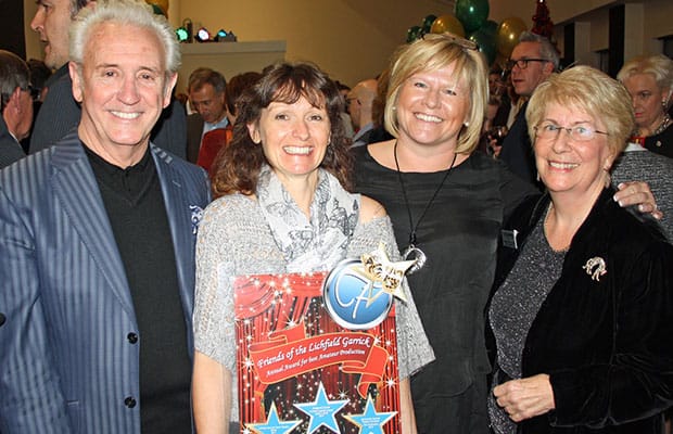 Tony Christie (left) presenting the Friends of the Garrick award for best amateur musical to Lichfield Operatic Society