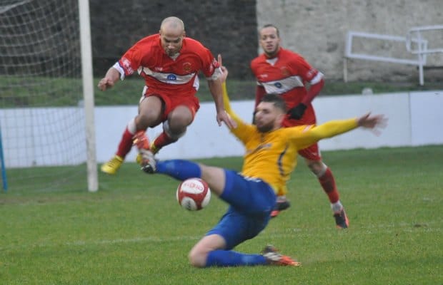 Simon Brown jumps clear of a sliding tackle