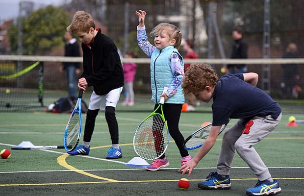 Young players try out a tennis coaching session