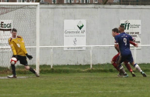 The Market Drayton keeper sees George Washbourne's shot skid past him. Pic: Dave Birt