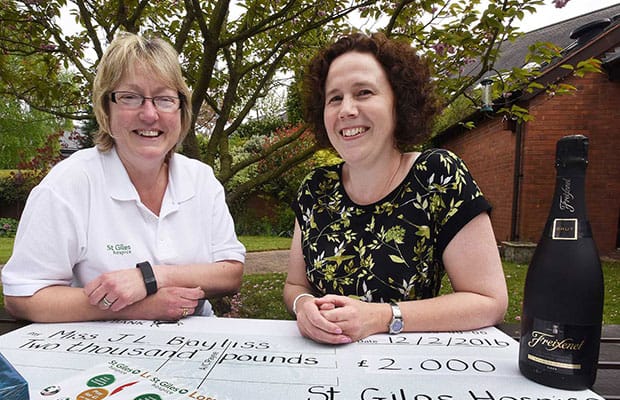 Lesley Holmes from St Giles Hospice with lottery winner Jo Bayliss