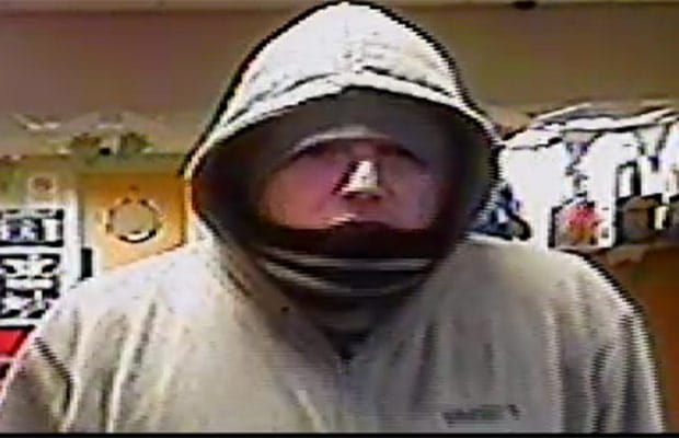 A CCTV image of the man with a Midlands accent who robbed a betting office in Newport