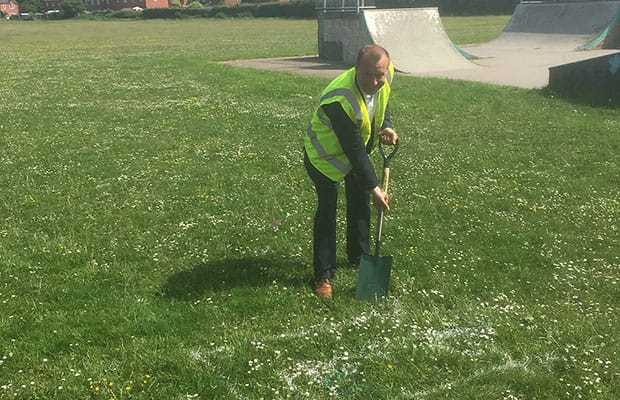Cllr Andy Smith digs the first part of the new parkour park in Burntwood