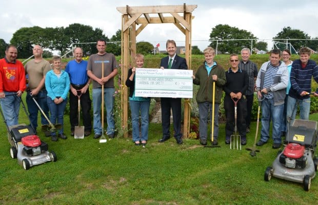 Police and Crime Commissioner Matthew Ellis hands over a cheque to members of Cherry Orchard Garden Services
