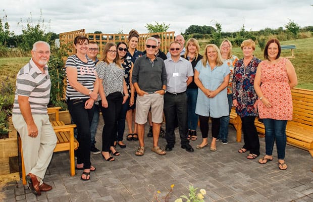 Mike Dolphin with members of the NEC team in the new St Giles Hospice garden