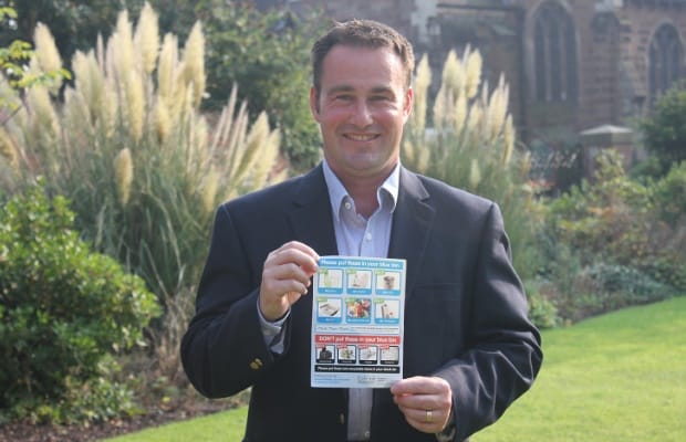 Cllr Iain Eadie with one of the new blue bin stickers