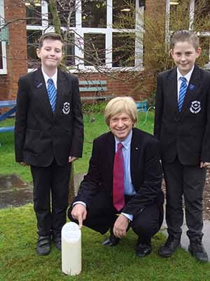Michael Fabricant buries a time capsule with members of the school council
