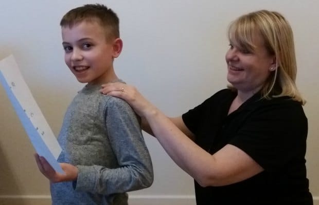 Sue Burford using Story Massage techniques on her son
