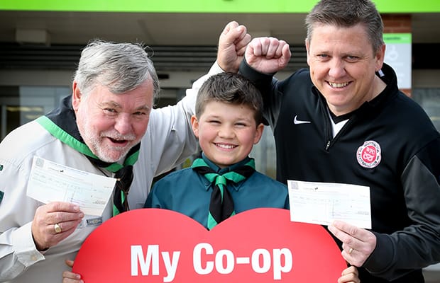 Representatives from 1st Lichfield St Chad’s Scout Group and Whittington Junior Football Club celebrate their windfall from Central England Co-operative's Community Dividend Fund