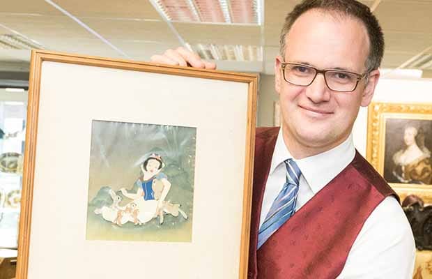 Charles Hanson with one of the cels from Snow White and the Seven Dwarfs
