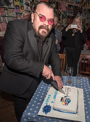 Roy Wood cuts the cake at the launch of the Lichfield Blues and Jazz Festival