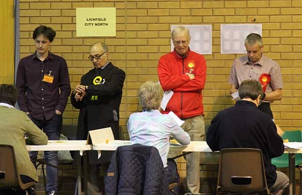 Candidates and agents looking on as the votes are verified
