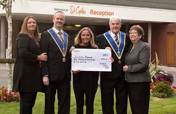 Clive and Pauline Andrews-Lewis, and Mike and Eunice Mason presenting the cheque to Carolyn Harris from St Giles Hospice