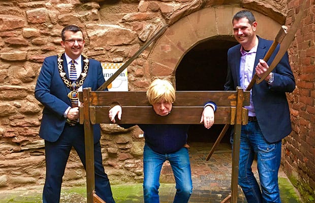 Michael Fabricant in the stocks and with Tamworth Borough Council's mayor Cllr John Chesworth and leader Cllr Daniel Cook