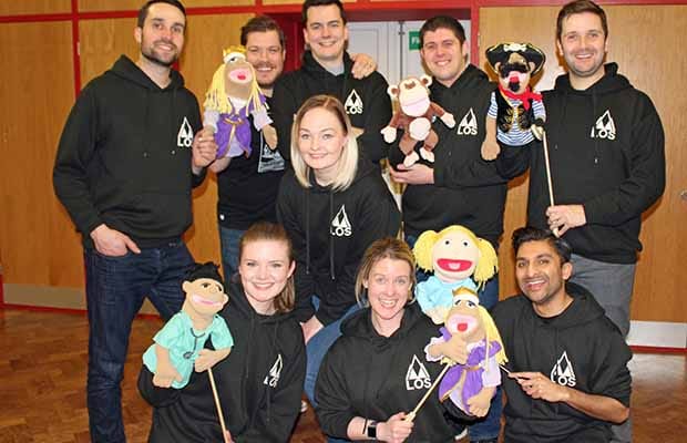 The cast of Avenue Q with some of the puppets