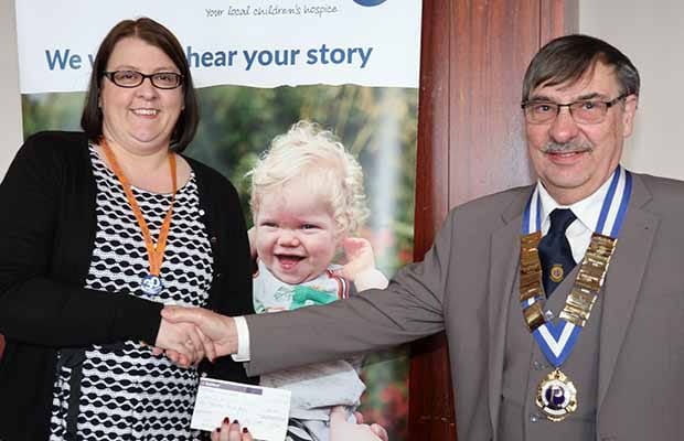 Ken Marshall hands over the cheque to Carol Pratt from Acorns Hospice