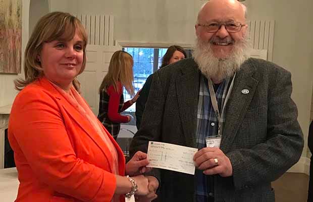 Samantha Beech presents the cheque to Peter Buck