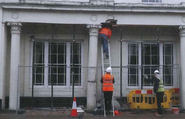 Workmen examining the damage at St Johns House