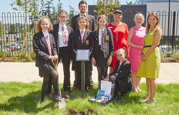 Students and teachers from the Friary School with staff from The Spires care home as the time capsule is buried