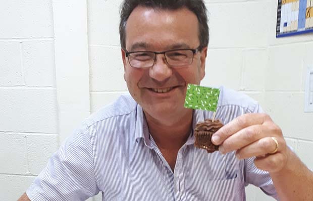 Auctioneer Richard Winterton tucking into one of the cakes