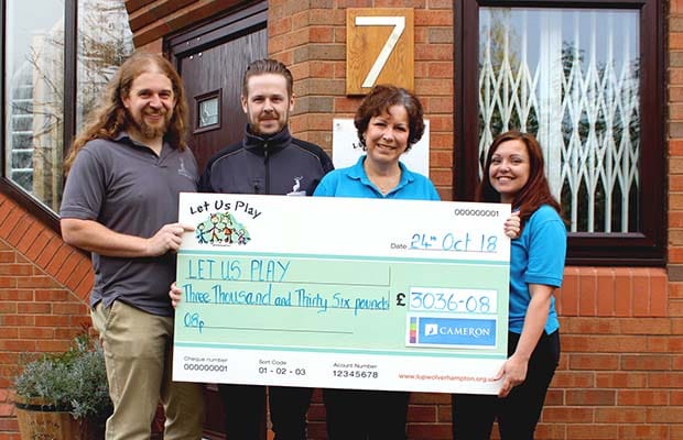 The fundraising cheque is handed over by Cameron Homes