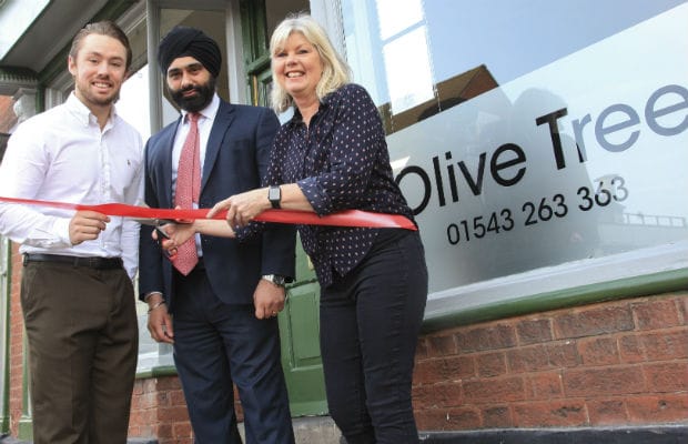 Matt Smith, Dan Pawar from HSBC and Yvonne Smith cutting the ribbon on the reopening of The Olive Tree in Lichfield