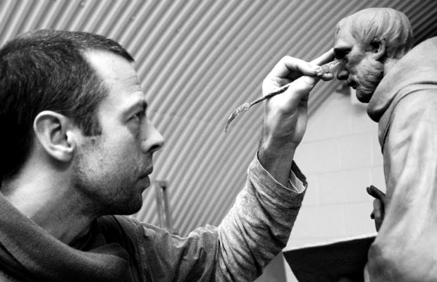 Artist Peter Walker working on a scaled model of the St Chad statue