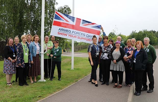 The Armed Forces Day flag being raised at the National Memorial Arboretum